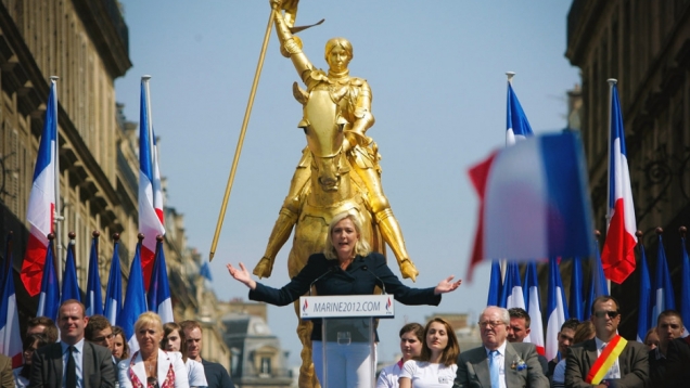 Joan of Arc looks down on far-right National Front leader Marine le Pen at a rally 2012.